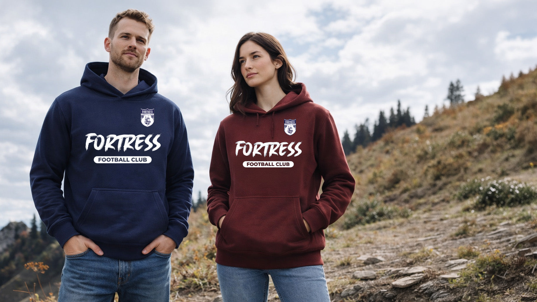 Two people wearing 'Fortress Football Club' hoodies in a natural setting.
